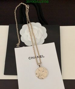 Elegant gold pendant necklace on branded background.