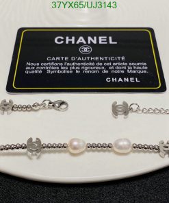 Chanel authenticity card with pearl bracelet and logo charms.