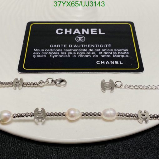 Chanel authenticity card with pearl bracelet and logo charms.