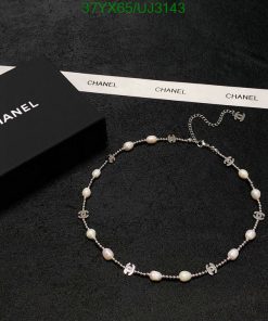 Chanel pearl necklace with logo on black background