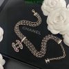 Elegant designer logo necklace with floral backdrop.