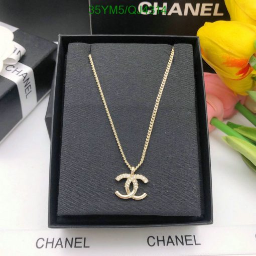 Gold pendant necklace in branded box.