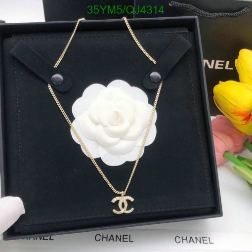 Gold designer logo necklace displayed in elegant box.