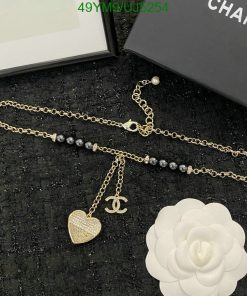 Gold chain necklace with heart pendant and pearl accents.