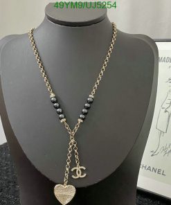 Gold chain necklace with heart pendant on mannequin.