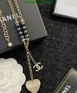 Elegant designer gold chain necklace with pearl and heart pendant.