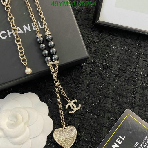 Elegant designer gold chain necklace with pearl and heart pendant.