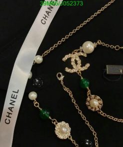 Designer pearl and gemstone necklace with ribbon and logo.