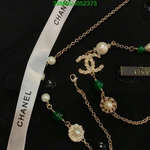 Designer pearl and gemstone necklace with ribbon and logo.