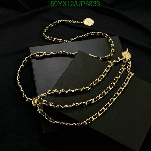 Gold chain necklace on black velvet with books.