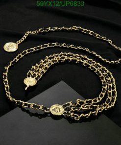 Gold chain belt with medallion details on black fabric.