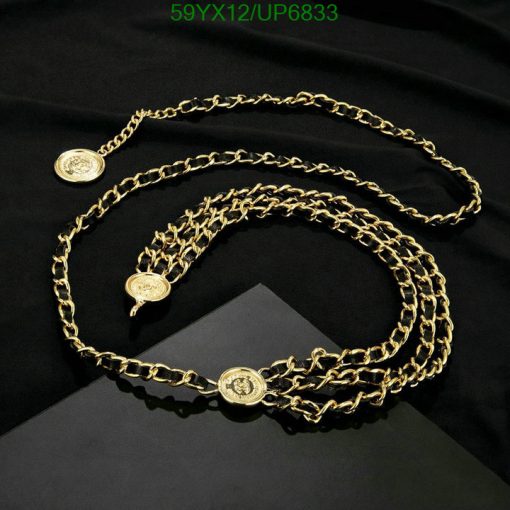 Gold chain belt with medallion details on black fabric.