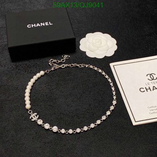 Elegant pearl and rhinestone necklace with packaging.