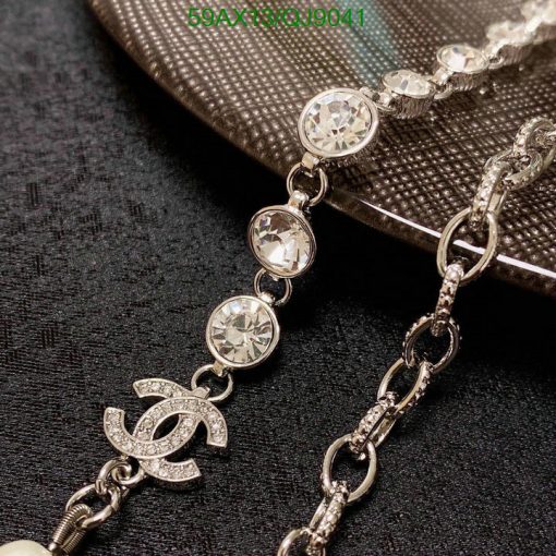 Elegant crystal necklace with designer logo detail.