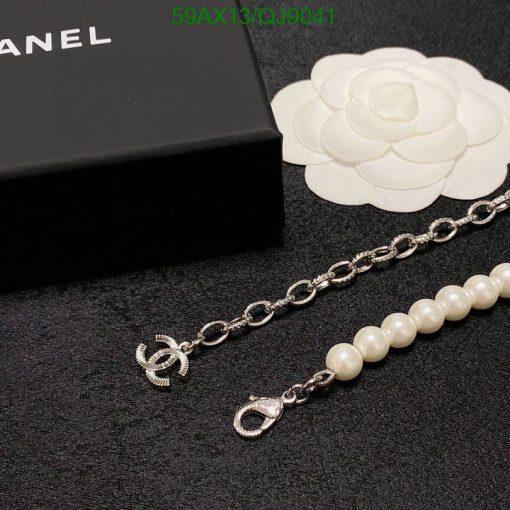 Chanel branded pearl bracelet near box and flower logo.