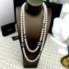 Elegant pearl necklace on display with silver details.