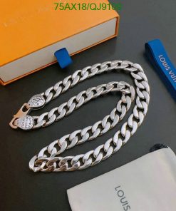 Silver chain necklace on table with branded box.