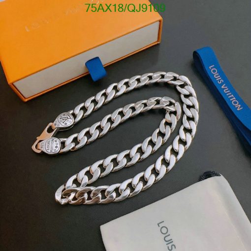 Silver chain necklace on table with branded box.