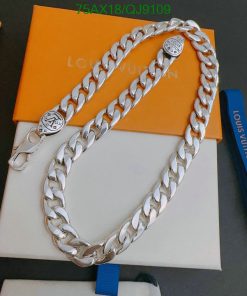 Silver designer chain on branded packaging.