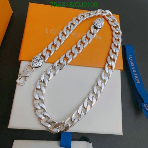 Silver designer chain on branded packaging.