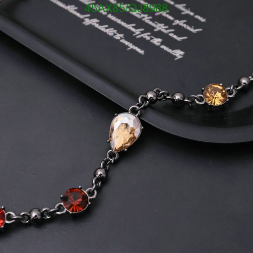 Elegant gemstone link bracelet on dark background.