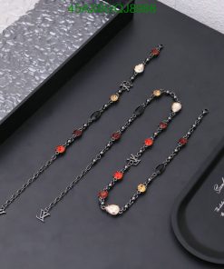 Elegant black and gold chain necklaces with red accents.