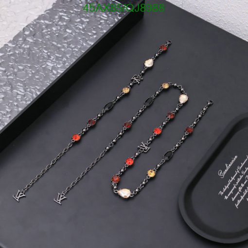 Elegant black and gold chain necklaces with red accents.