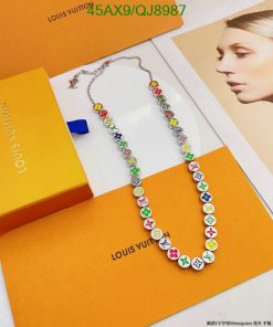 Colorful designer necklace on branded packaging.