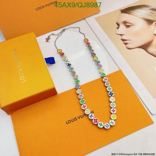 Colorful designer necklace on branded packaging.