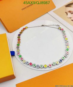 Colorful designer logo necklace on display with packaging.
