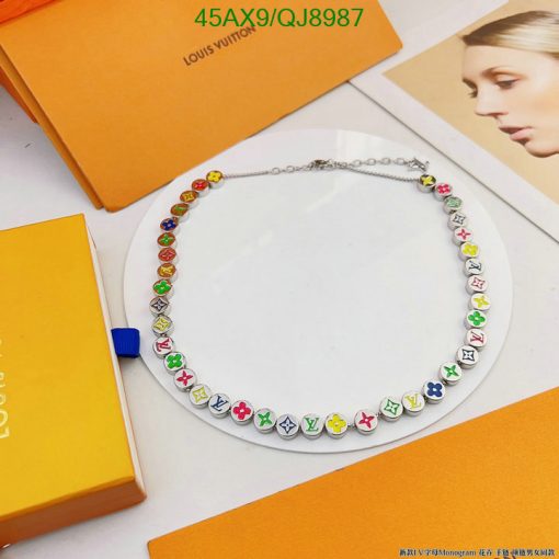 Colorful monogram necklace on display with brand boxes.