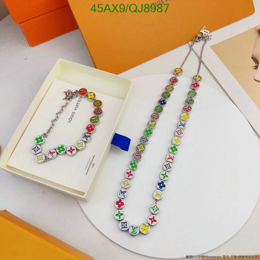 Colorful charm necklace on display with packaging.
