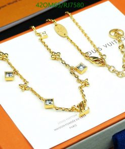 Gold charm bracelets with brand logo on packaging.