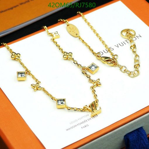 Gold charm bracelets with brand logo on packaging.