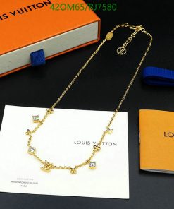 Gold charm necklace on branded packaging with box.