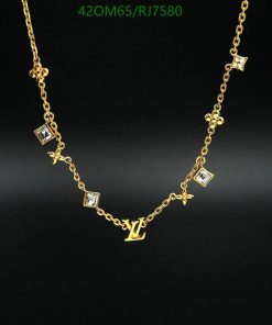 Gold necklace with diamond accents and designer initials.