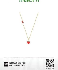 Designer gold necklace with red heart pendant.