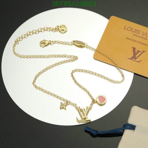 Designer gold-tone charm necklace with brand card.