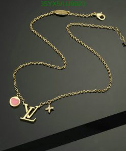 Gold charm necklace on dark background