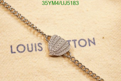 Silver heart pendant on branded background.