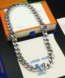 Silver designer chain necklace on branded packaging.