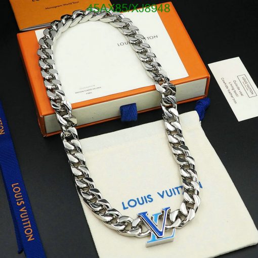 Silver designer chain necklace on branded packaging.