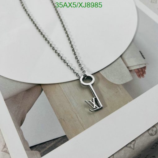 Silver key pendant necklace with letter V design.