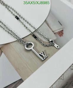 Designer key and letter pendants on chain.