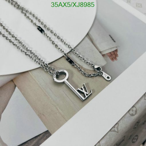 Designer key and letter pendants on chain.