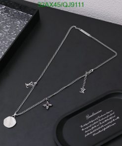 Silver necklace with pendant on black display.