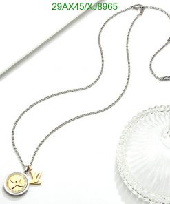 Silver necklace with golden pendant on white background.