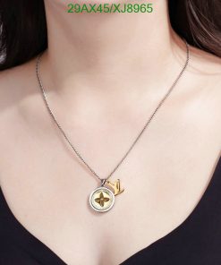 Woman wearing gold pendant necklace.