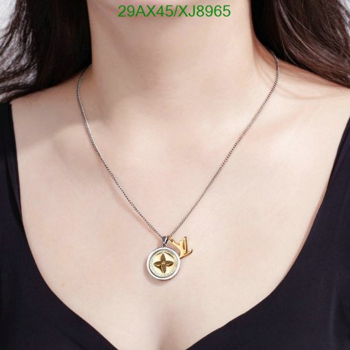 Woman wearing gold pendant necklace.