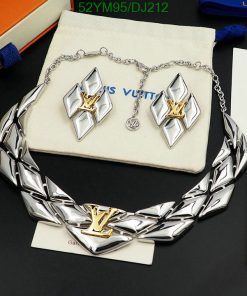 Silver designer necklace and earrings set on display.